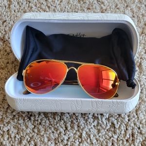 Woman's Oakley Tie Breaker Polarized Sunglasses- Gold Ruby color.